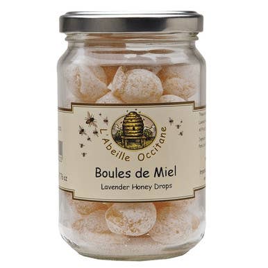 Jar of 'Boules de Miel' lavender honey drops with a visible label on a white background