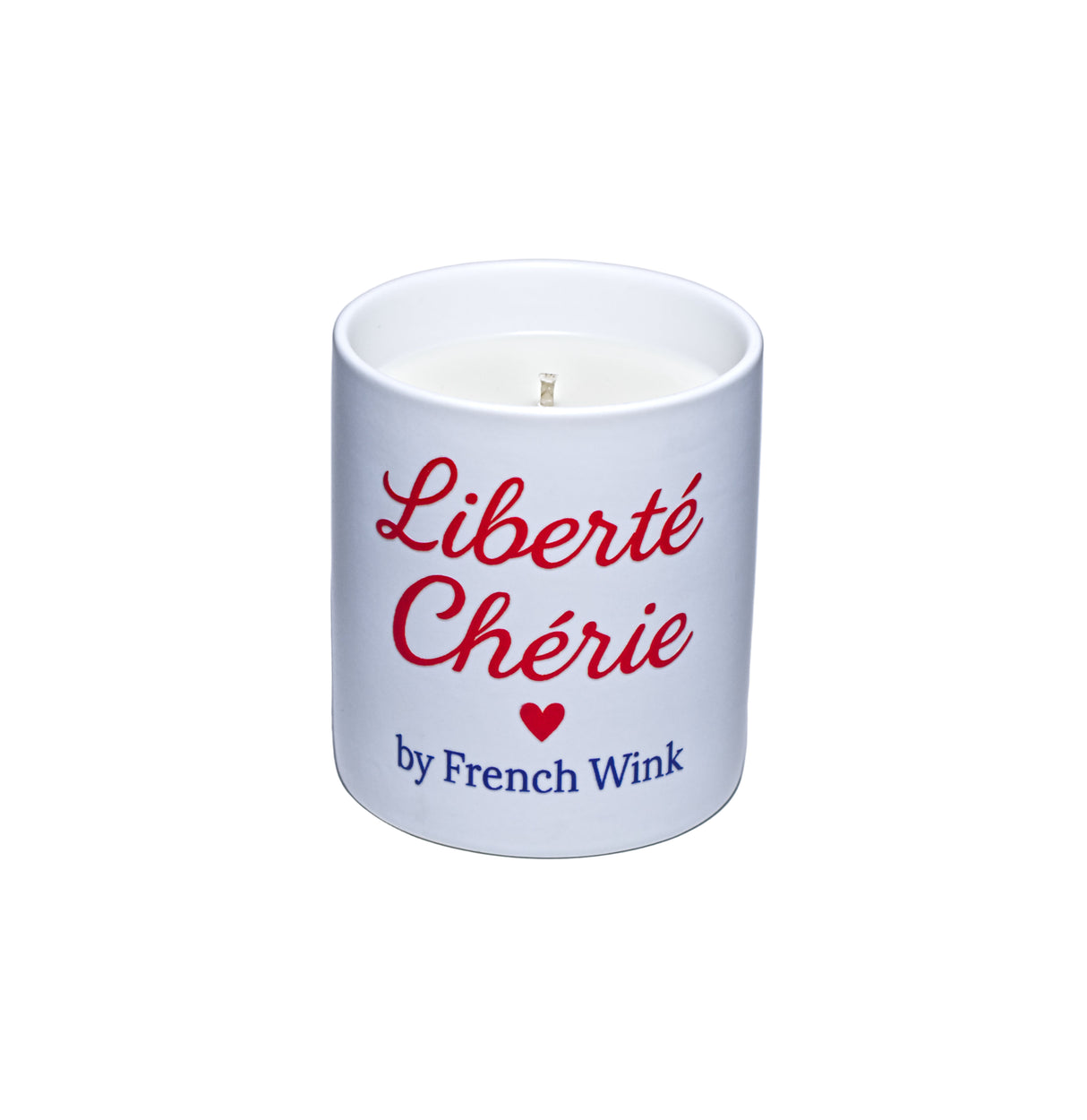 White candle with red text 'Liberté Chérie' and a heart symbol, branded by French Wink on a light gray background.