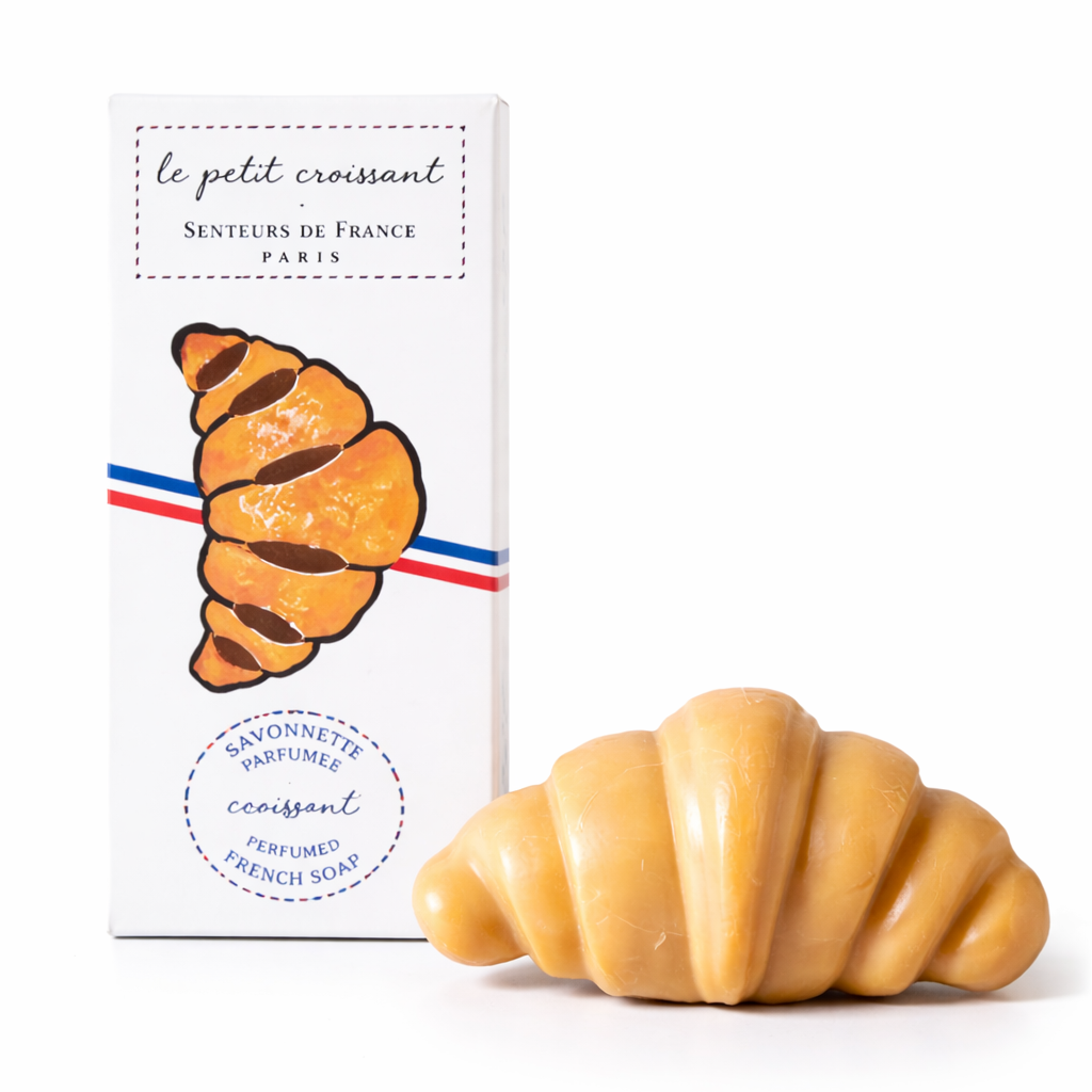 Soap shaped like a croissant with packaging on a white background