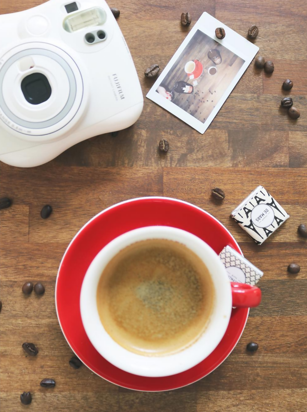 Red Cappuccino Cup on a table with coffee beans by Cafe Richard