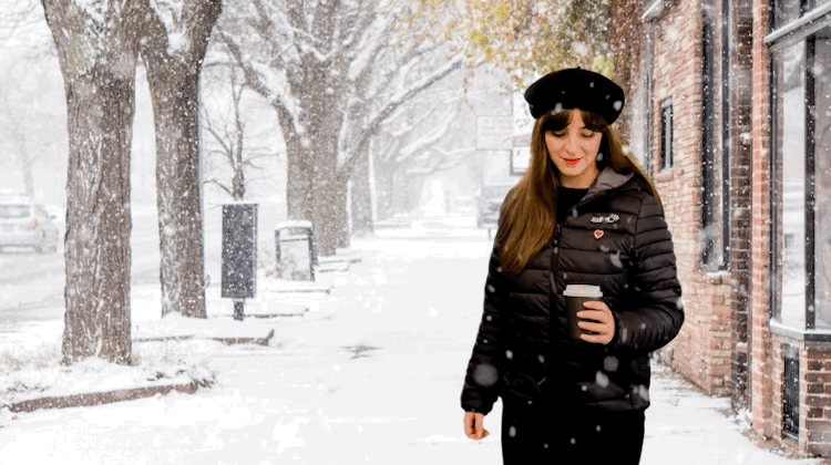 women wearing a french wink puffer jacket in a snowy street