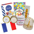Collection of French-themed products including candles, baguette soap, and an Eiffel Tower snow globe