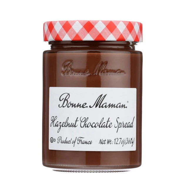 A glass jar of Bonne Maman Hazelnut Chocolate Spread with a red and white checkered lid, on a solid white background.