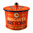 A vintage-style metal biscuit tin with a lid, featuring the text 'BISCUITS BRETONS' and 'PUR BEURRE' on a bright orange-red background with gold and navy lettering and decorative flour motifs.