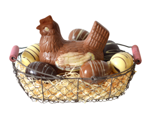 A milk chocolate hen and assorted chocolate eggs in a wire basket, resembling a French Easter treat.
