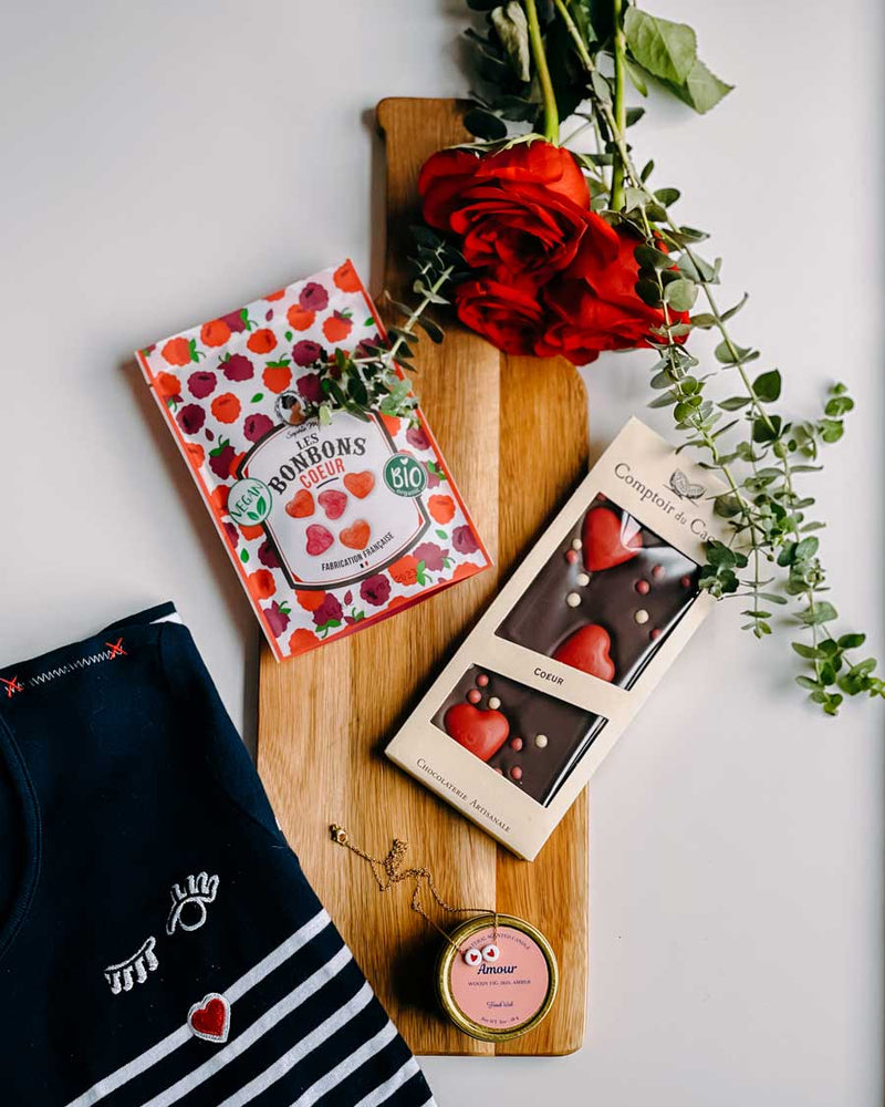 valentine's day gifts on a table including a french stripe shirt, jewelry, french chocolate and candy
