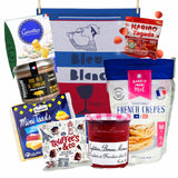 Assorted French food products including a kitchen towel labeled 'Bleu Blanc Rouge' and various packaged items.