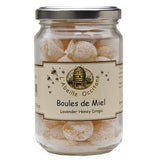 Jar of 'Boules de Miel' lavender honey drops with a visible label on a white background