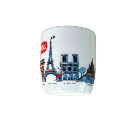 Ceramic mug with Paris-themed design featuring Eiffel Tower and Notre Dame on a white background