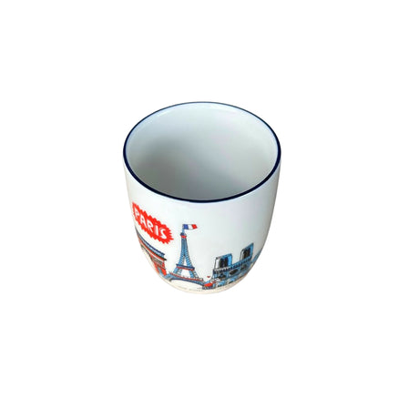 Ceramic mug with Paris-themed design on a gray background