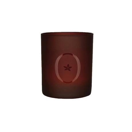 A brown scented candle with a star-shaped design on the upper part of the candle.
