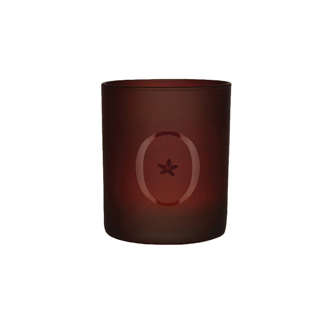 A brown scented candle with a star-shaped design on the upper part of the candle.
