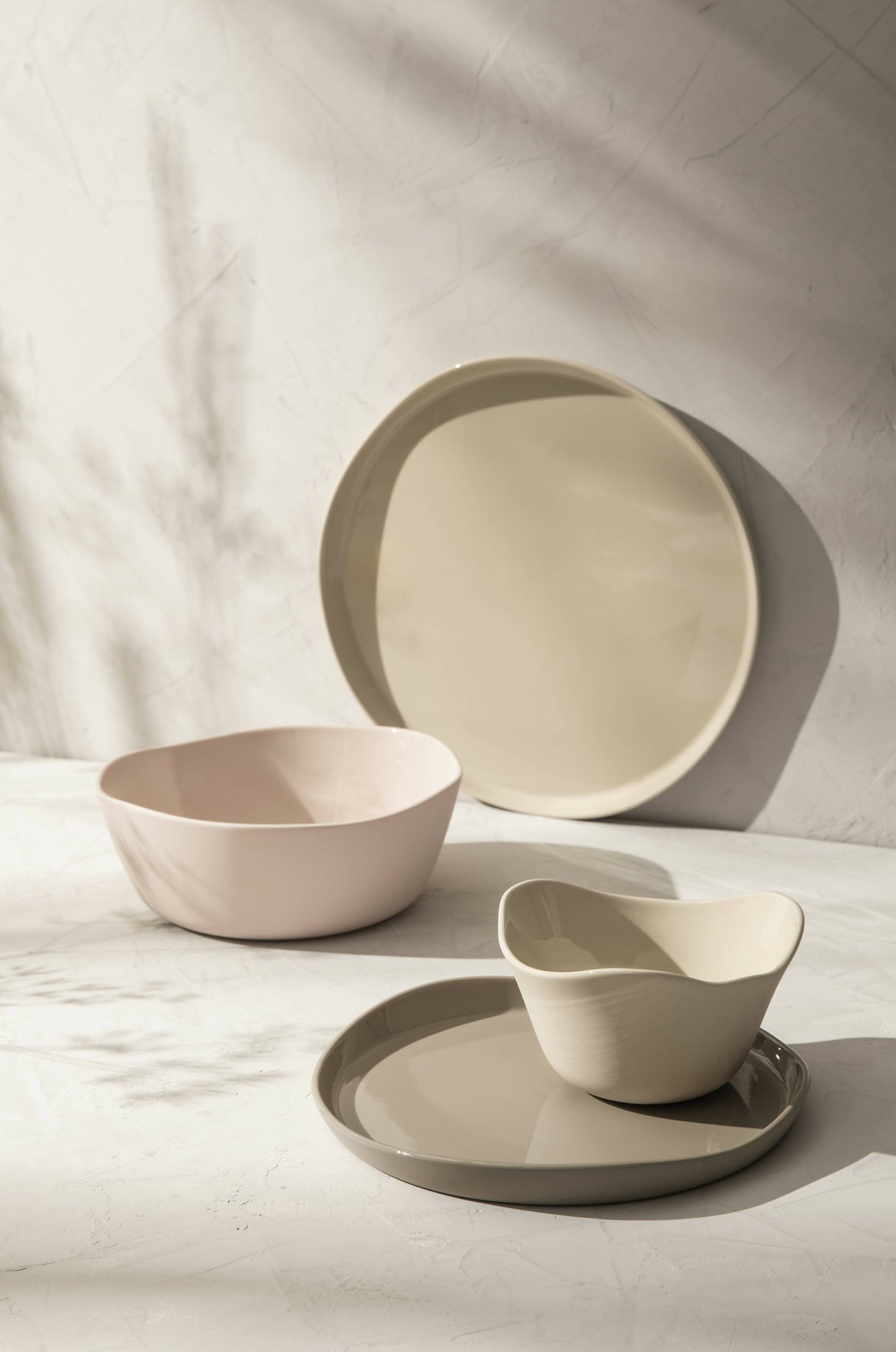 a set of Degrenne Paris Beige with two plates and two bowls on a table